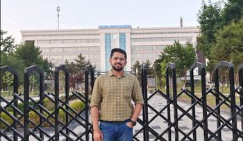 Shobhit Jayaswal standing in front of the building of Tashkent Medical Academy.
